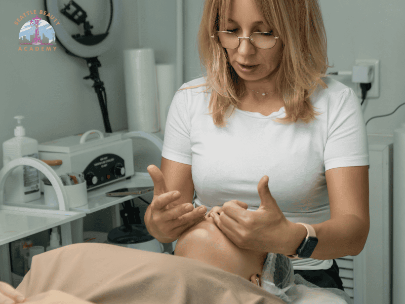 Seattle Beauty Academy's instructors are teaching facial massage in the esthetics classes