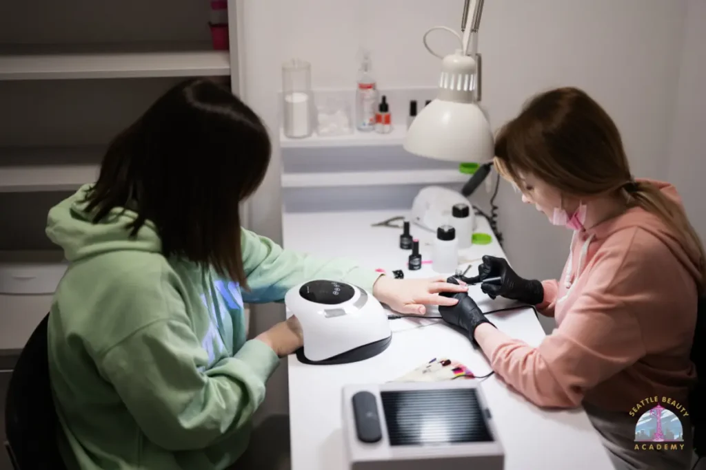 Modern nail salon setup with LED UV lamp, gel polish collection, and chrome nail art tools on technician workstation