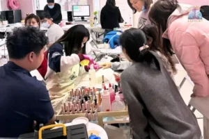 Seattle Beauty Academy manicure students practicing chrome nail techniques in hands-on salon training class