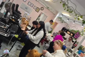 Latina hair design student smiling after passing her Washington State cosmetology license exam at Seattle Beauty Academy