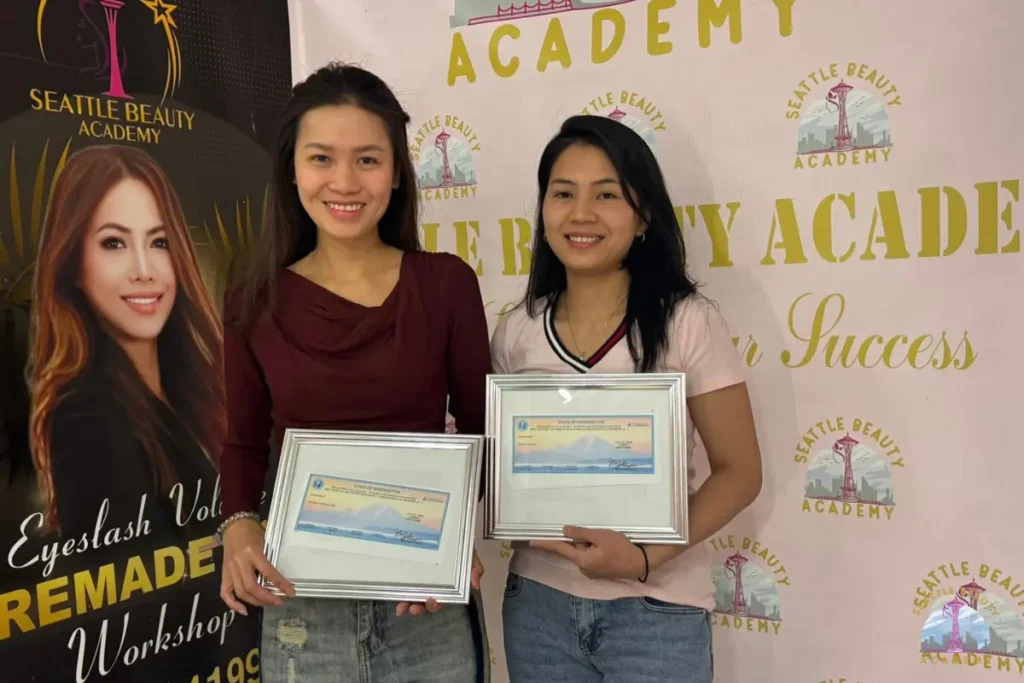 Seattle Beauty Academy graduates holding Washington State manicure licenses
