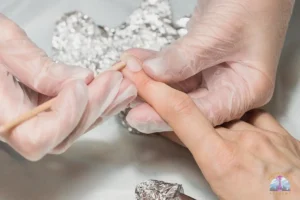 Nail tech implements soaking in EPA-registered disinfectant following Washington State sanitation standards