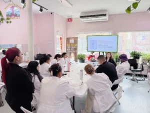Esthetics students are listening to the instructor during theory lessions at Seattle Beauty Academy, WA