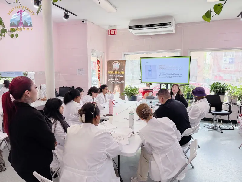 Esthetics students are listening to the instructor during theory lessions at Seattle Beauty Academy, WA