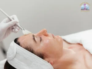 Licensed master esthetician applying a chemical peel brush treatment — an advanced procedure exclusive to Washington master esthetician license holders