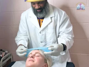 Seattle Beauty Academy esthetics student Lorenzo Hill performs a facial treatment on a live client during hands-on training at the school's student clinic in Seattle, WA