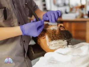 Student barber practicing beard trimming techniques under instructor supervision at Seattle Beauty Academy