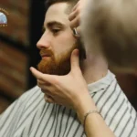 Barber student shaping a client's beard during hands-on beard grooming techniques training at Seattle Beauty Academy