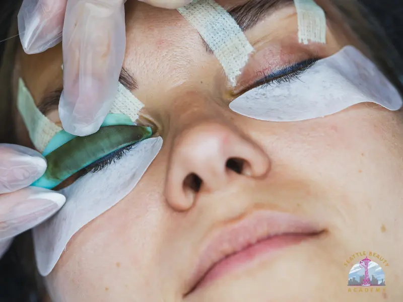 Esthetics student practicing professional lash application at Seattle Beauty Academy