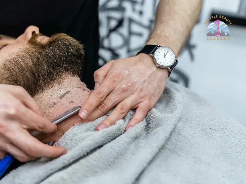 Professional neckline shaving technique demonstrated during a beard grooming techniques course in Seattle