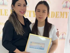 A nail tech holding her Washington license