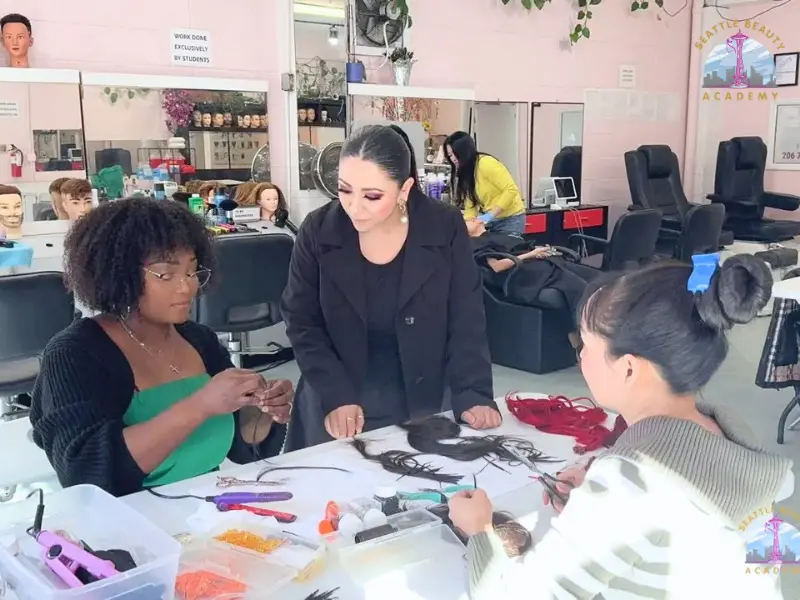 Beauty school classroom with students receiving hands-on cosmetology training