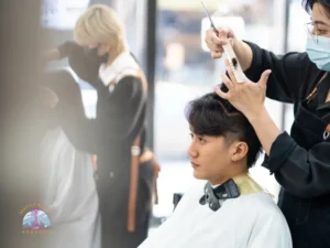 Beauty school student practicing hairstyling techniques during hands-on training