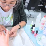 Washington nail technician student practicing nail techniques