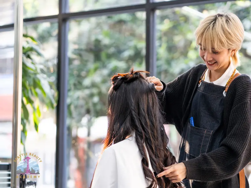 Beauty school student is practicing hair cutting on real client