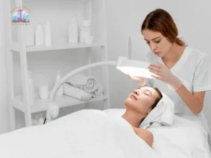 Professional esthetician examining a client’s facial skin before treatment