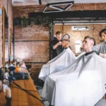 Professional hairstylist demonstrating hair cutting techniques