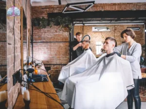 Professional hairstylist demonstrating hair cutting techniques