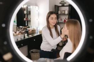 Close-up of professional artist making up for her client