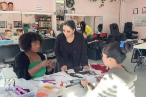 Cosmetology instructor explaining to her student about melanin, oxidation, and pigment changes in hair coloring