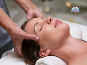 Esthetics student practicing facial massage technique on a live client