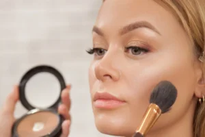 Professional makeup artist applying natural makeup with brushes